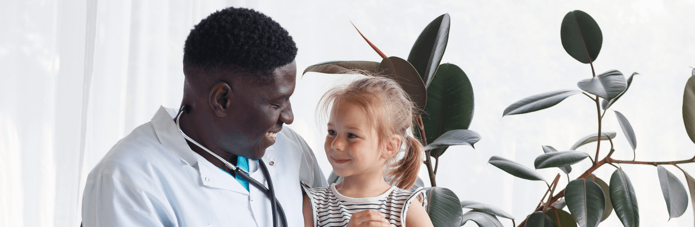 A doctor smiling warmly at a child patient, creating a comforting and reassuring atmosphere in the medical setting